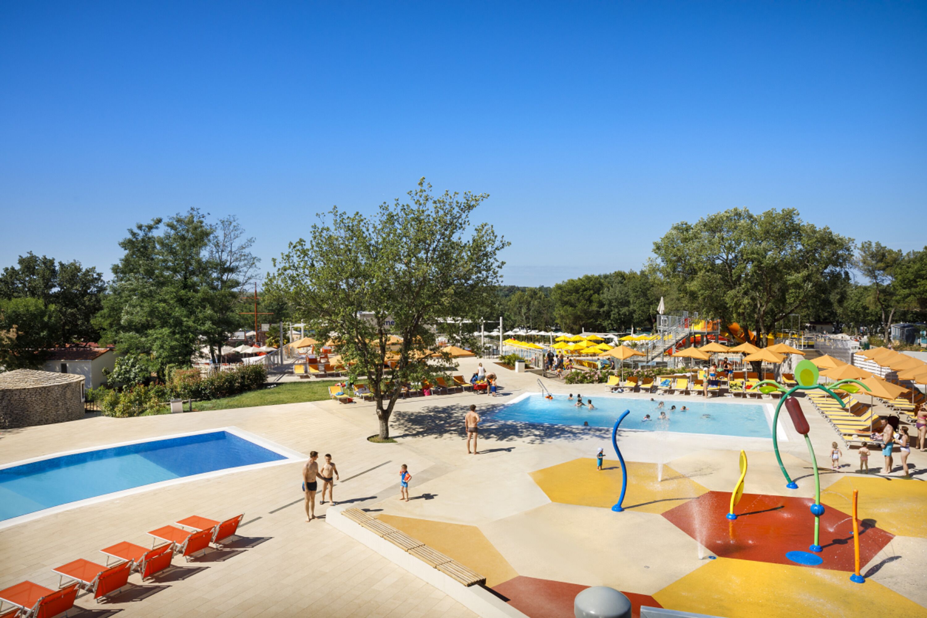 A water park with multiple pools, slides, and play areas.
