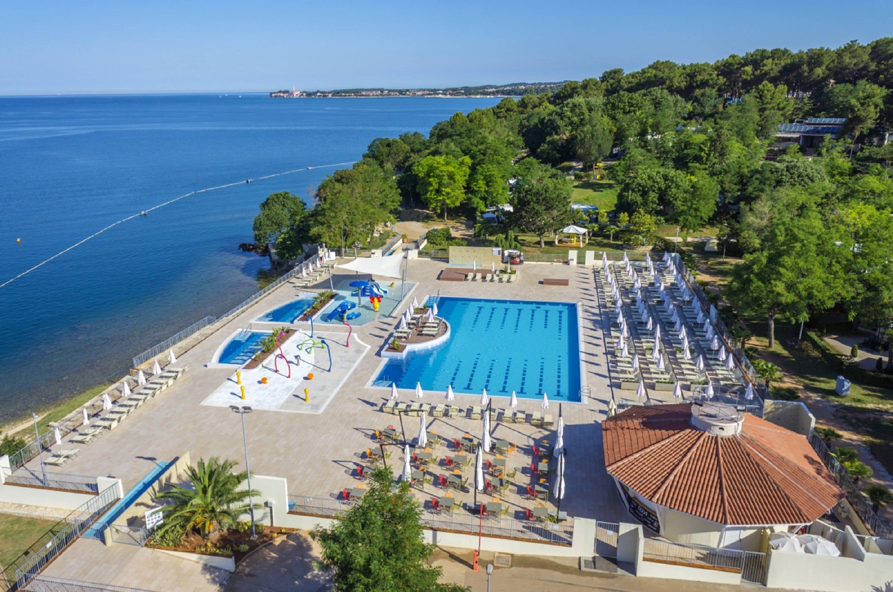 Outdoor pool, a heated pool, pool umbrellas, pool loungers