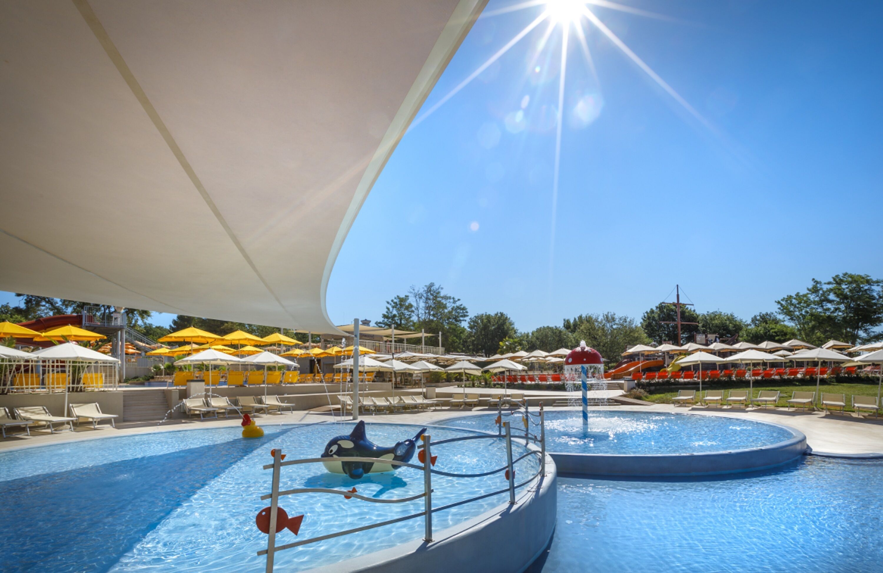Outdoor pool, a heated pool, pool umbrellas, pool loungers