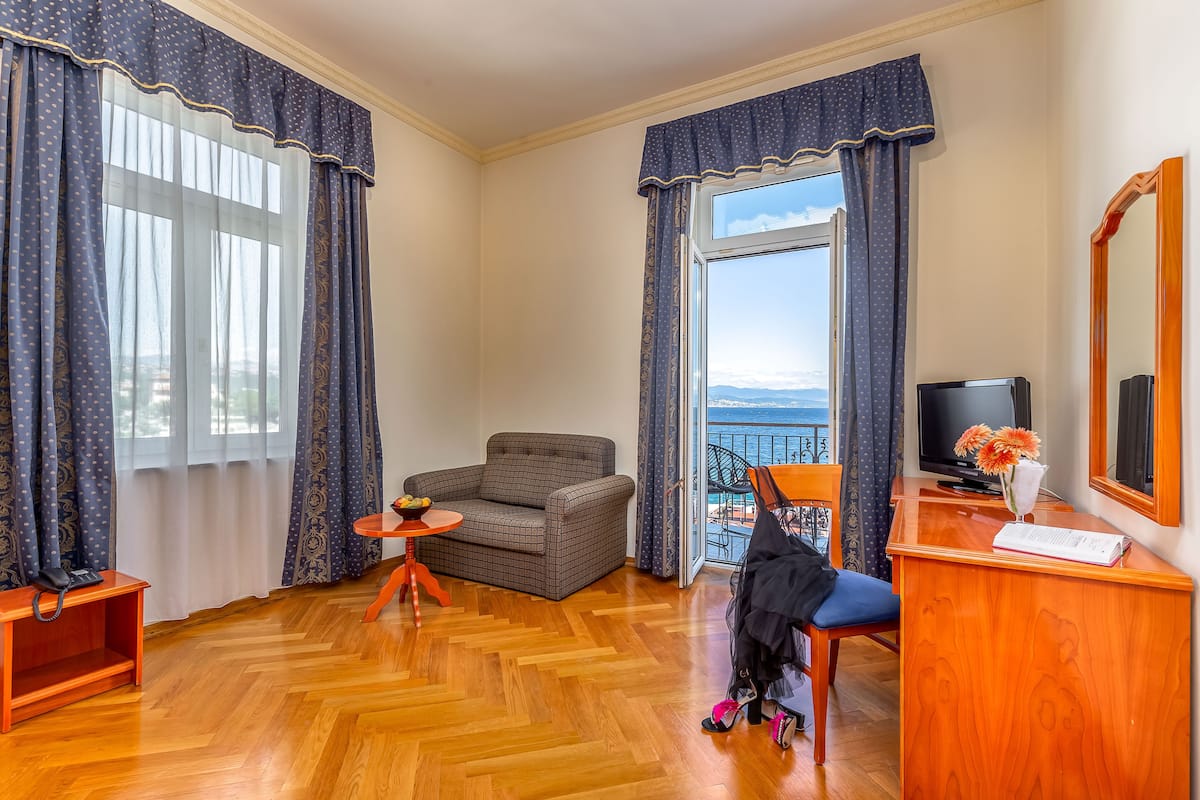 Standard Suite, Balcony, Sea View | Minibar, in-room safe, desk, laptop workspace