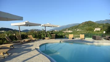 Seasonal outdoor pool, open 9:00 AM to 7:00 PM, pool umbrellas