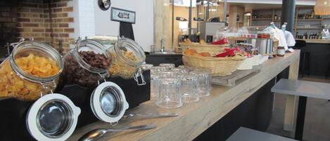 A buffet area with various food items in jars and baskets, and a sign that reads "A Taste!".