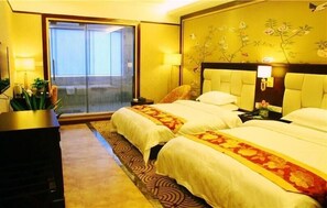 A hotel room with two beds, a large window, and a view of a building. - zhangjiajie Lantian Hotel (Zhangjiajie)