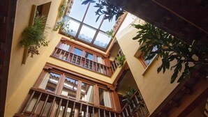 Un edificio de varios pisos con balcones de madera y ventanas grandes.