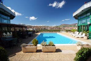 Outdoor pool, open 7:00 AM to 11:00 PM, sun loungers