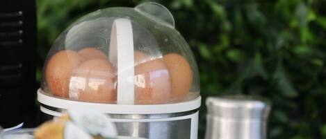 A breakfast setup with eggs, a coffee pot, and a yogurt container.