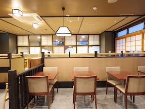 A restaurant interior with booths, tables, and a counter. - Dormy Inn Toyama Natural Hot Spring (Toyama)