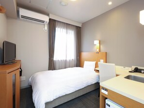 A hotel room with a bed, a desk with a chair, a television, a sink, and an air conditioning unit. - Dormy Inn Toyama Natural Hot Spring (Toyama)