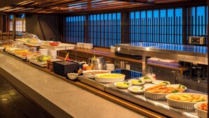 A buffet setup with various dishes and serving utensils. - Dormy Inn Toyama Natural Hot Spring (Toyama)