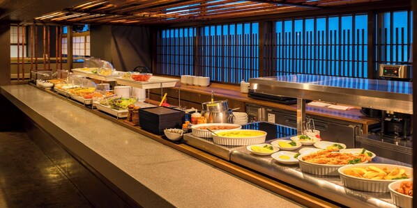 A buffet setup with various dishes and serving utensils. - Dormy Inn Toyama Natural Hot Spring (Toyama)