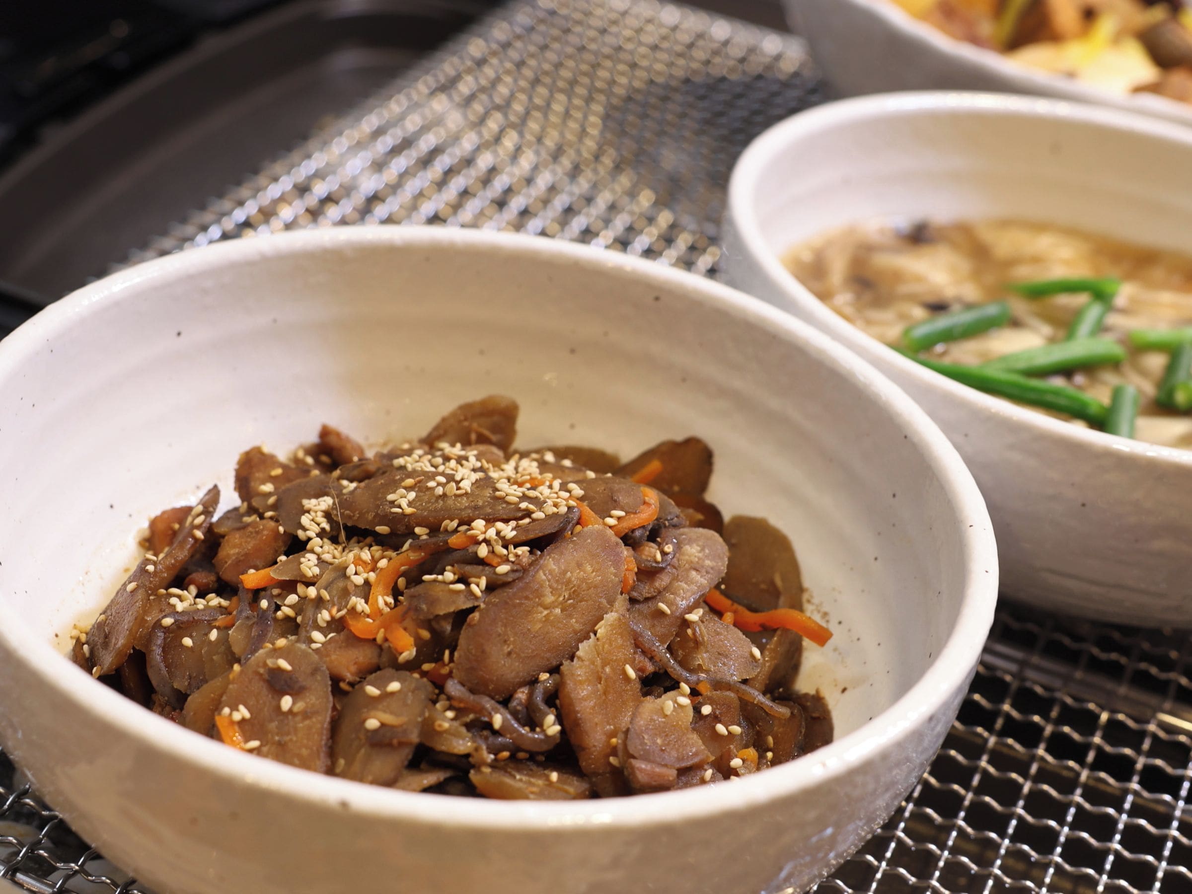 A bowl of food with sesame seeds on top.