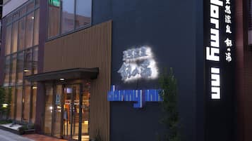 A building with a modern facade, large windows, and a prominent sign with Japanese characters.