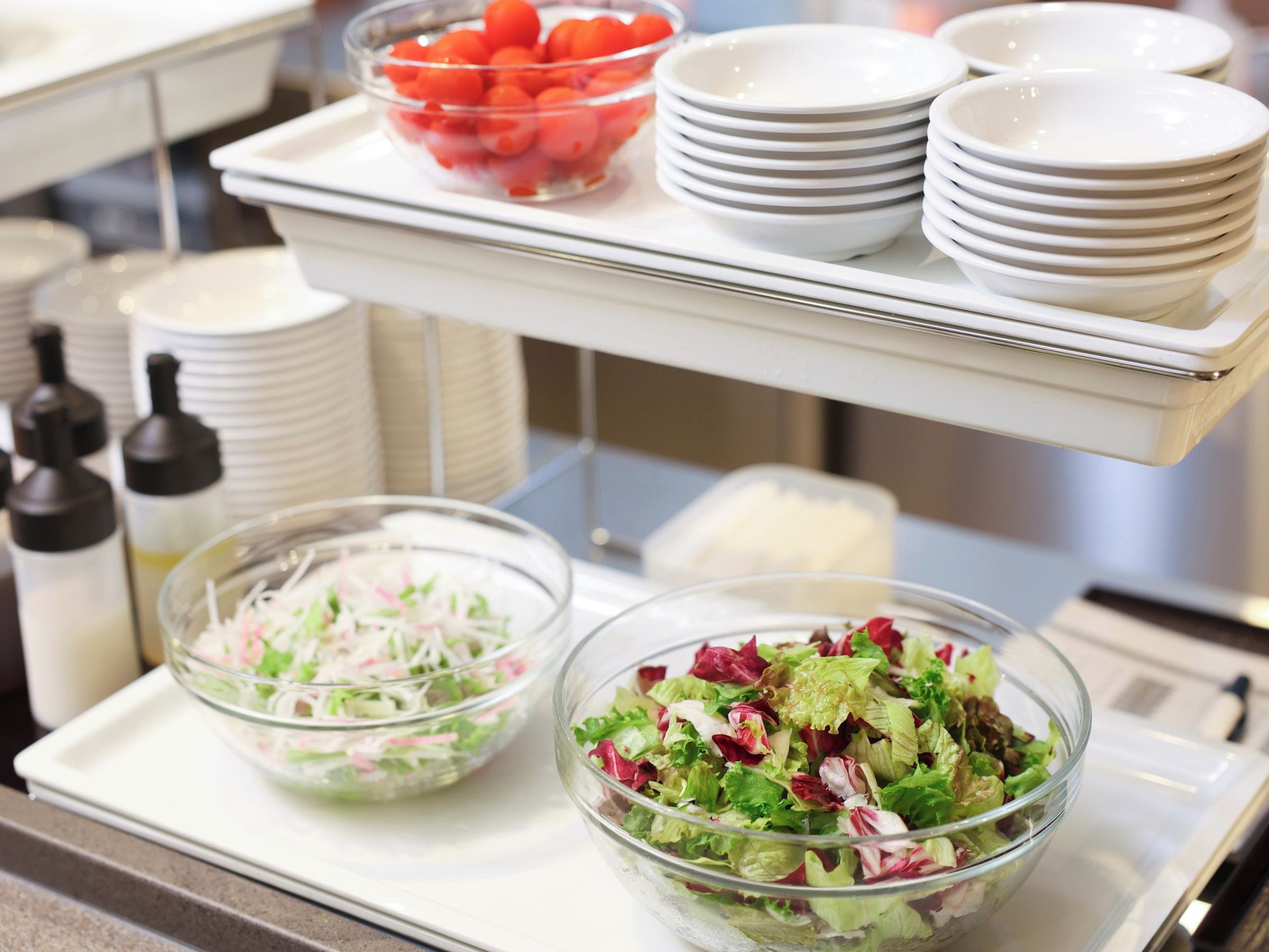 A buffet setup with various dishes and condiments.