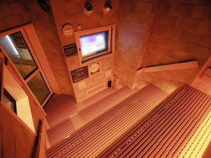 A staircase with a wooden floor and a television screen mounted on the wall. - Dormy Inn Toyama Natural Hot Spring (Toyama)