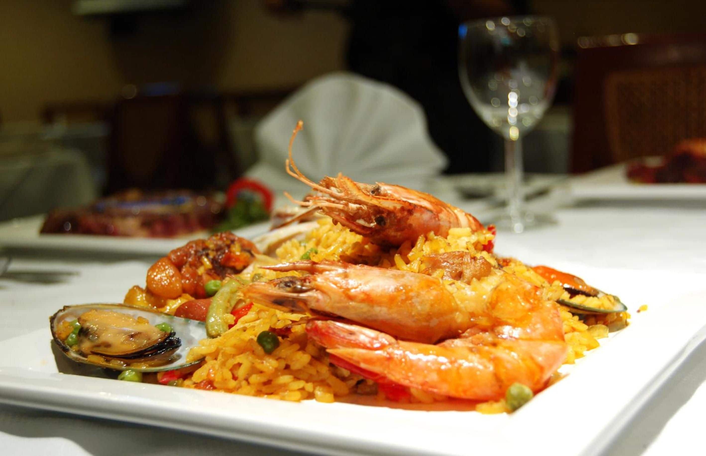 A seafood dish with shrimp and mussels on a white plate.