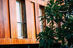A modern building with vertical wooden panels and large windows.