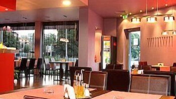 A restaurant interior with tables, chairs, and hanging lights. - Hotel Mone (Plovdiv)