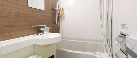 A modern bathroom with a white sink, a toilet, a shower with a curtain, and a mirror on the wall.