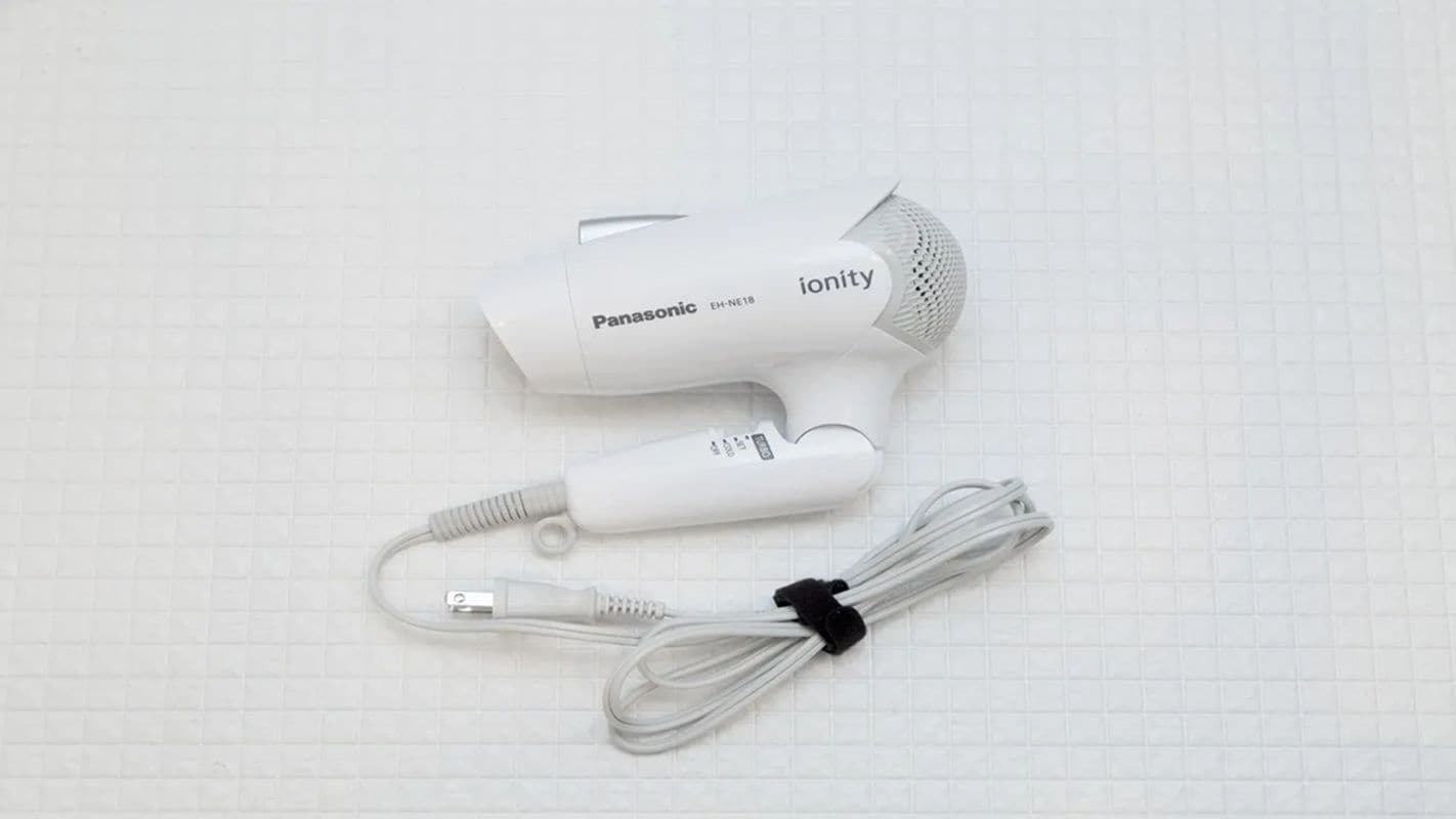 A Panasonic ionity hair dryer with a white cord and power adapter.