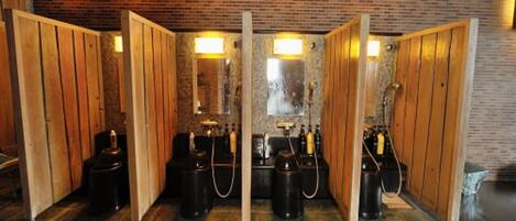 A spa area with wooden partitions, a brick wall, and gas cylinders.