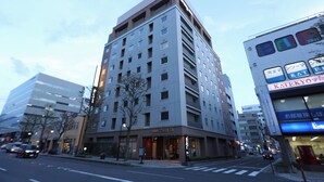 A multi-story hotel with a modern design, featuring a prominent entrance and signage. - Dormy Inn Matsumoto Natural Hot Spring (Matsumoto)