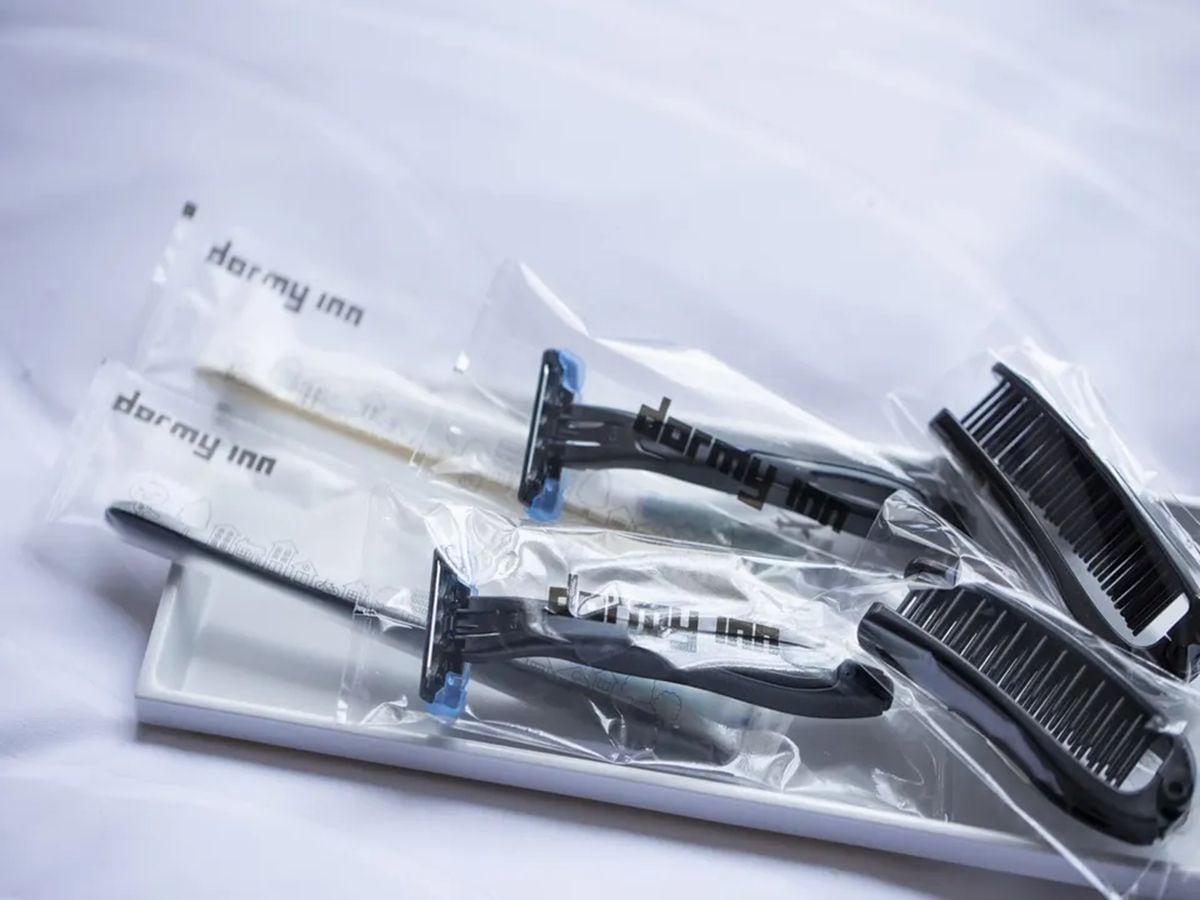 A set of grooming tools including scissors, a comb, and a razor, all packaged in clear plastic bags.