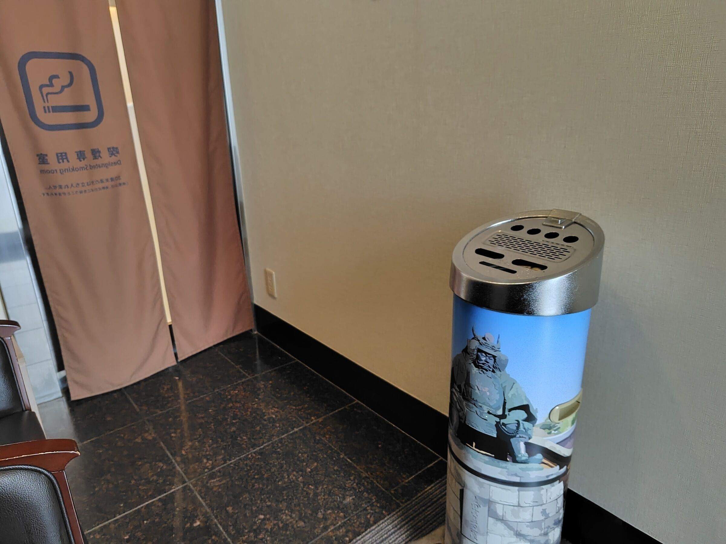 A trash can with a graphic of a Viking in a castle.