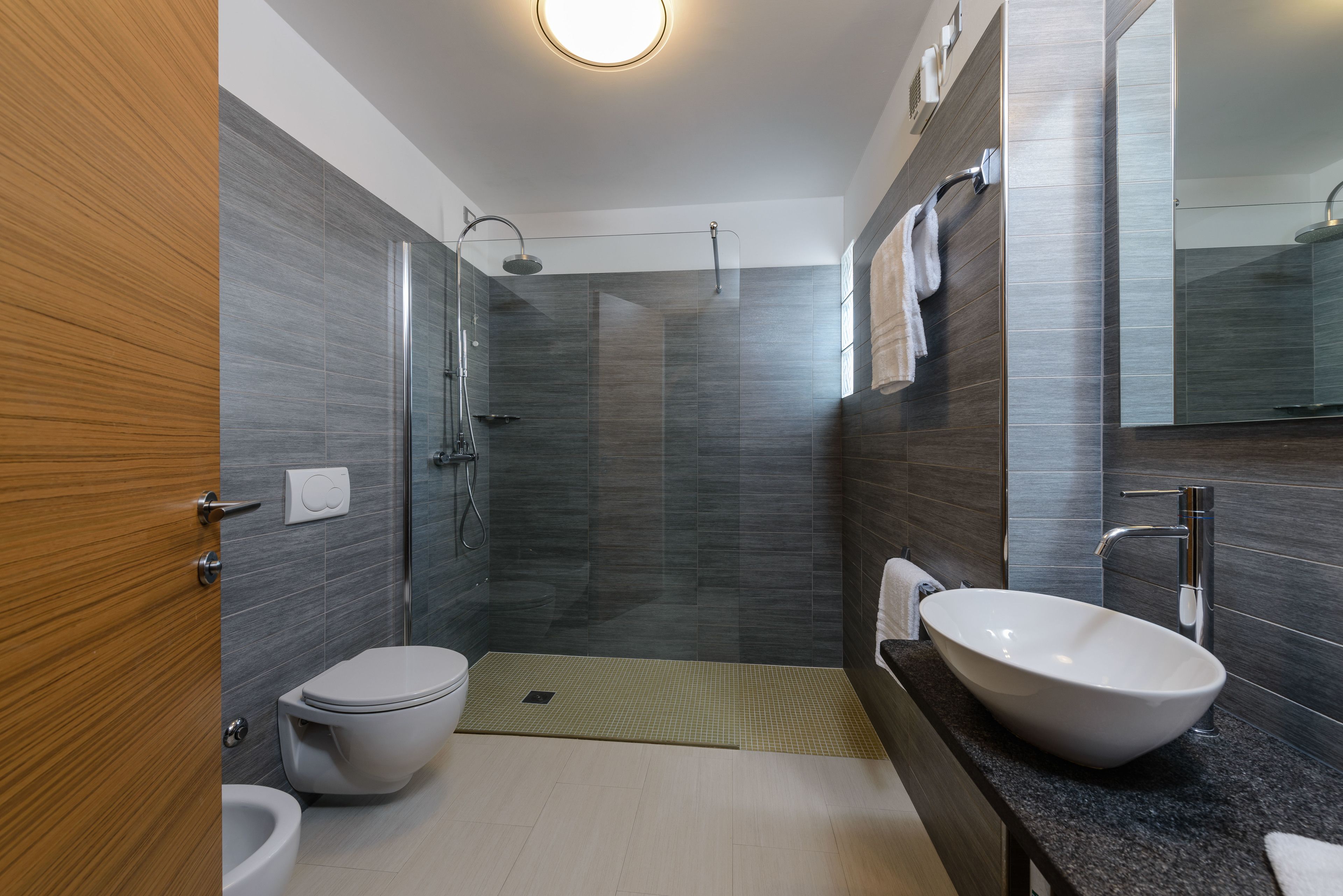 junior suite | bathroom | shower, hair dryer, slippers, bidet