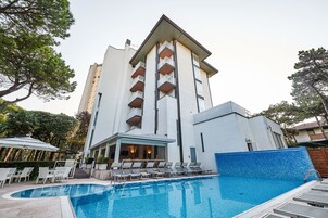 Una piscina al aire libre de temporada, sombrillas