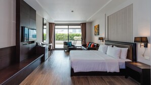 A modern hotel room with a large bed, a desk, a chair, and a balcony with a view of the city.