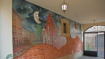A hallway with a large mural depicting a cityscape and a moon.