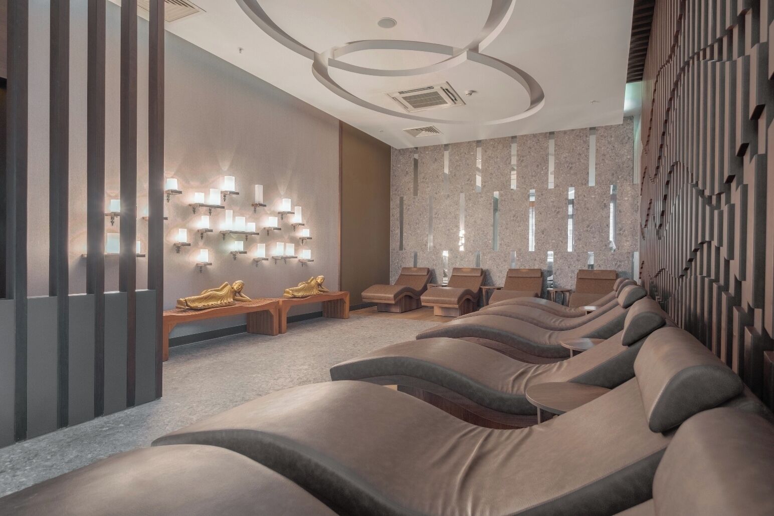 A spa area with massage chairs, a wall-mounted light fixture, and a ceiling design.