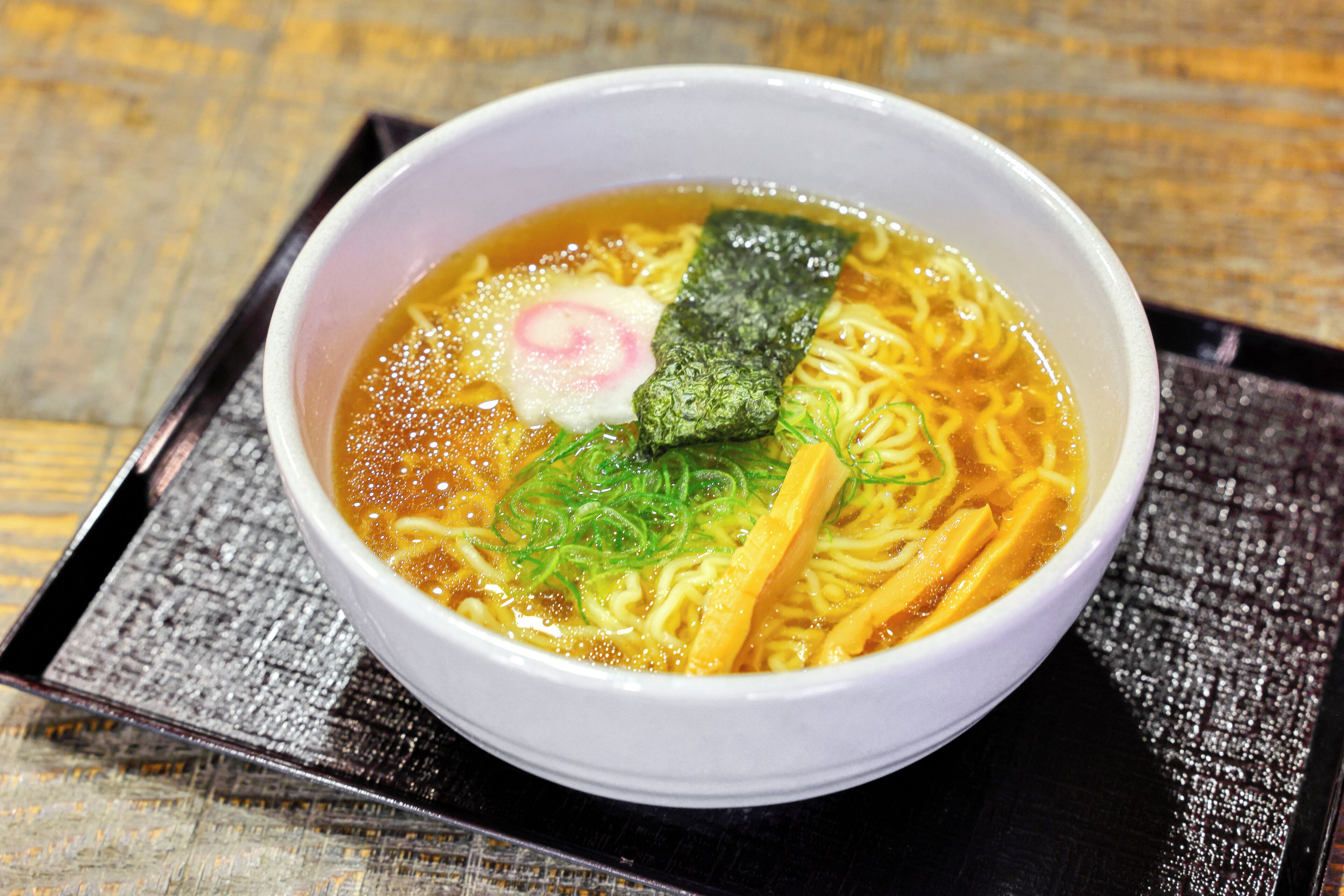 A bowl of ramen with toppings.