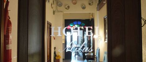 A hotel entrance with a sign reading "HOTEL METRO."