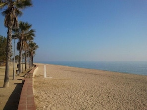 Beach nearby, white sand, beach umbrellas, beach towels