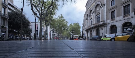 A street with parked cars and a building with a sign that reads "BLOV".