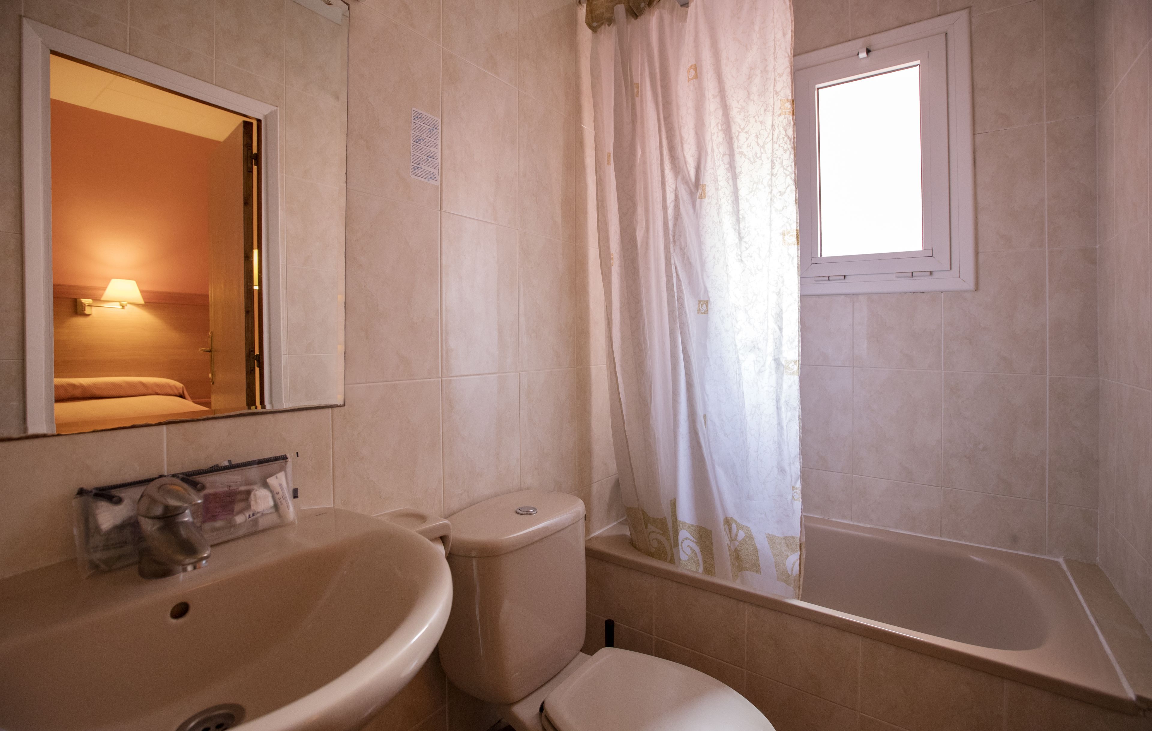 A bathroom with a sink, toilet, and bathtub.