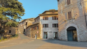 A street view of a historic building with a sign for "Hotel & Ristorante" on the ground floor. - Hotel San Pietro (Assisi)