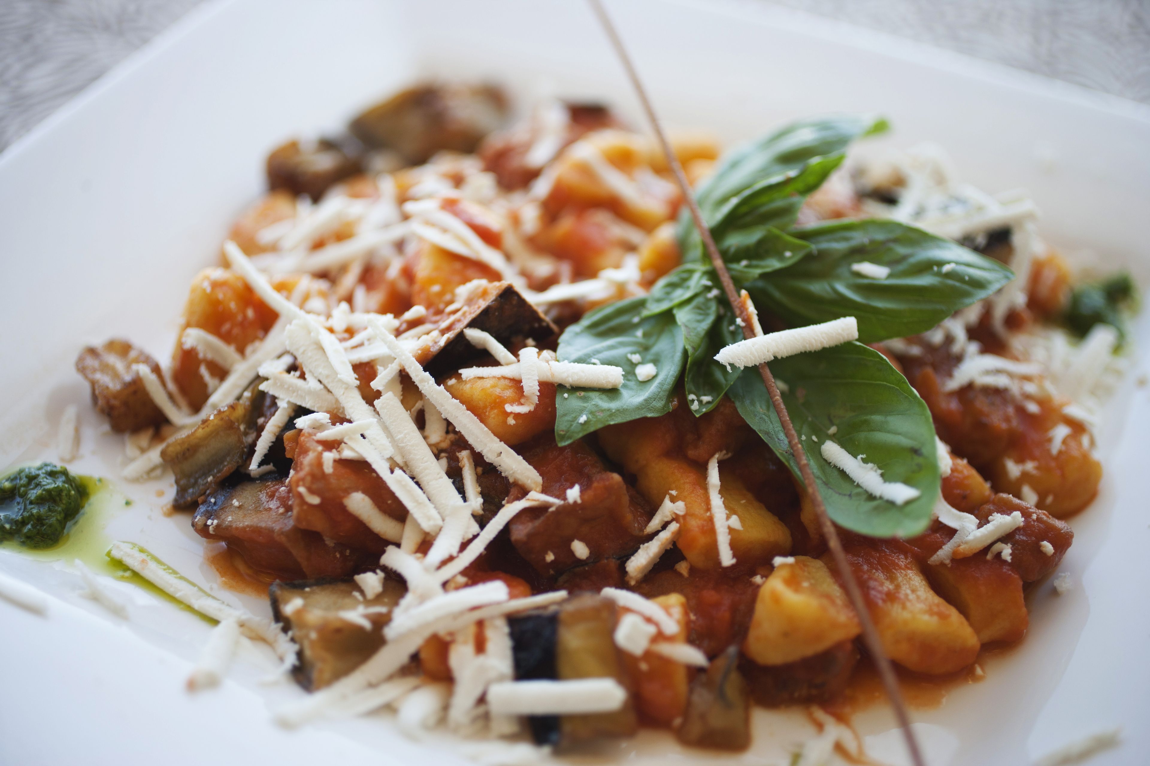 A plate of pasta with vegetables and cheese.