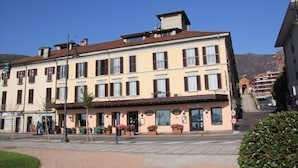 A hotel with a traditional facade, multiple windows, and a visible entrance.