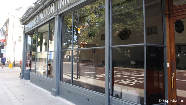 The exterior of the Islington Inn hotel with large windows, a classic facade, and a visible street view. - Islington Inn (London)