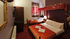 A hotel room with two beds, a mirror, a heater, a wardrobe, and a window with curtains. - Islington Inn (London)