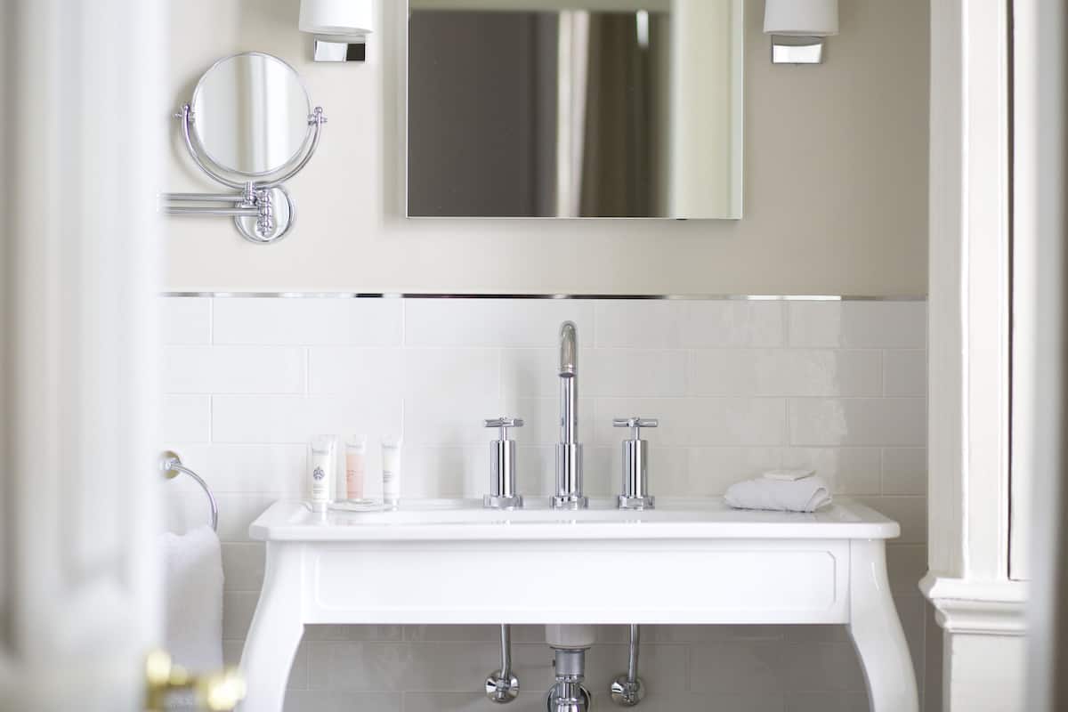 designer toiletries, hair dryer, towels