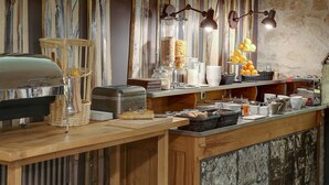 A buffet setup with various food items, a toaster, and a coffee machine.