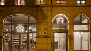 A historic building with arched entrances, a library, and a café area.