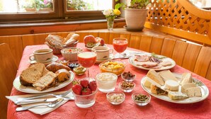 A breakfast setting with various foods and drinks on a table. - La Fischhutte, The Originals Relais (Mollkirch)