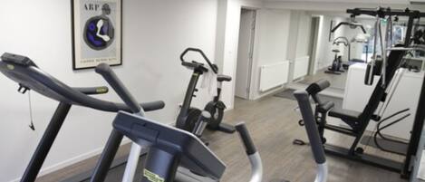 A gym with treadmills, stationary bikes, and weight machines.