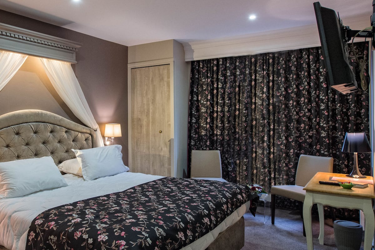 Premium bedding, desk, laptop workspace, blackout drapes