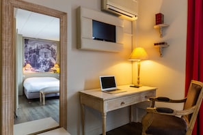 Relax in a stylishly designed room with a comfortable bed, desk, and flat-screen TV.