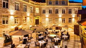 An outdoor patio area with tables and chairs, a hot tub, and umbrellas. - The von Stackelberg Hotel Tallinn (Tallinn)